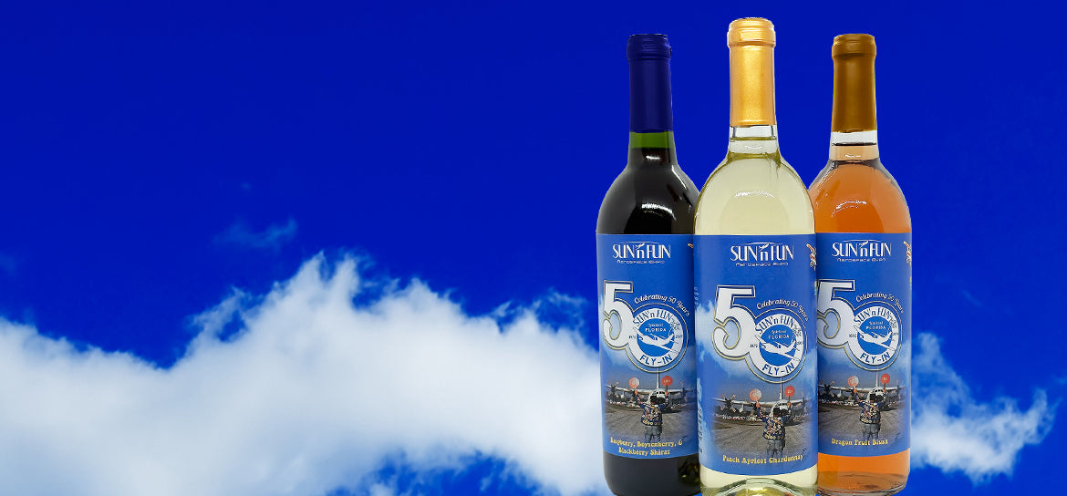 SUN n FUN wine bottles with blue sky and clouds in background
